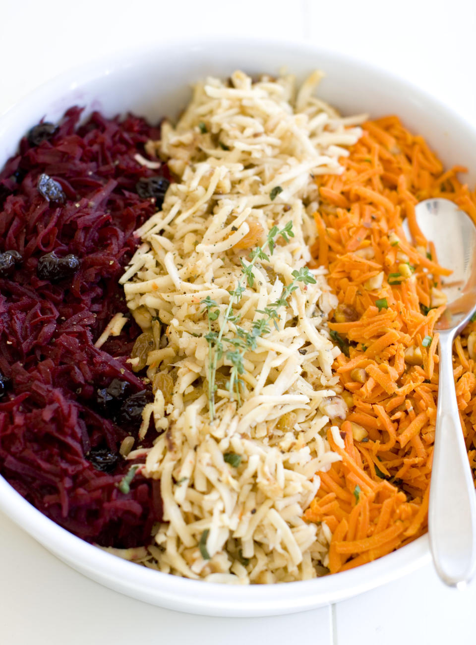 This Nov. 18, 2013 photo shows, from left, shredded beets with balsamic, shredded parsnips with walnuts, and shredded spicy carrots, in Concord, N.H. (AP Photo/Matthew Mead)