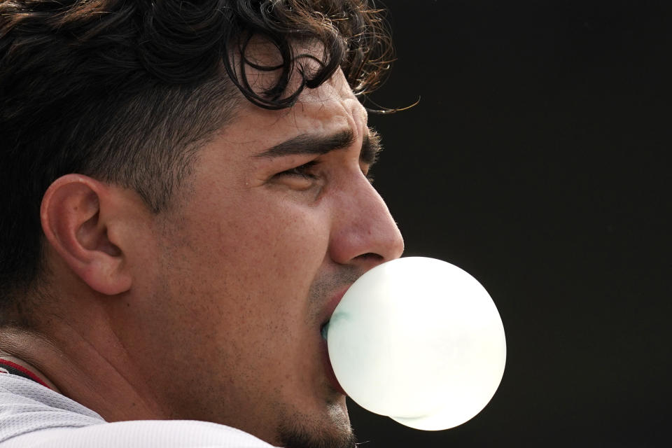 Arizona Diamondbacks' Josh Rojas blows a bubble in the dugout after hitting a solo home run during the seventh inning of a baseball game against the Chicago Cubs in Chicago, Friday, May 20, 2022. (AP Photo/Nam Y. Huh)