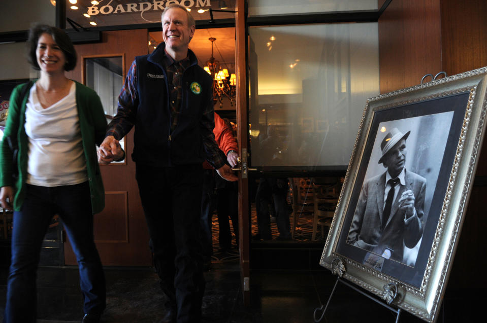 Republican gubernatorial primary candidate Bruce Rauner and his wife, Diana, leave a campaign stop at Johnny's Italian Steakhouse, Monday, March 17, 2014, in Moline, Ill. Rauner faces state Sens. Bill Brady and Kirk Dillard and state Treasurer Dan Rutherford in Tuesday's primary. (AP Photo/The Dispatch, Todd Mizener)