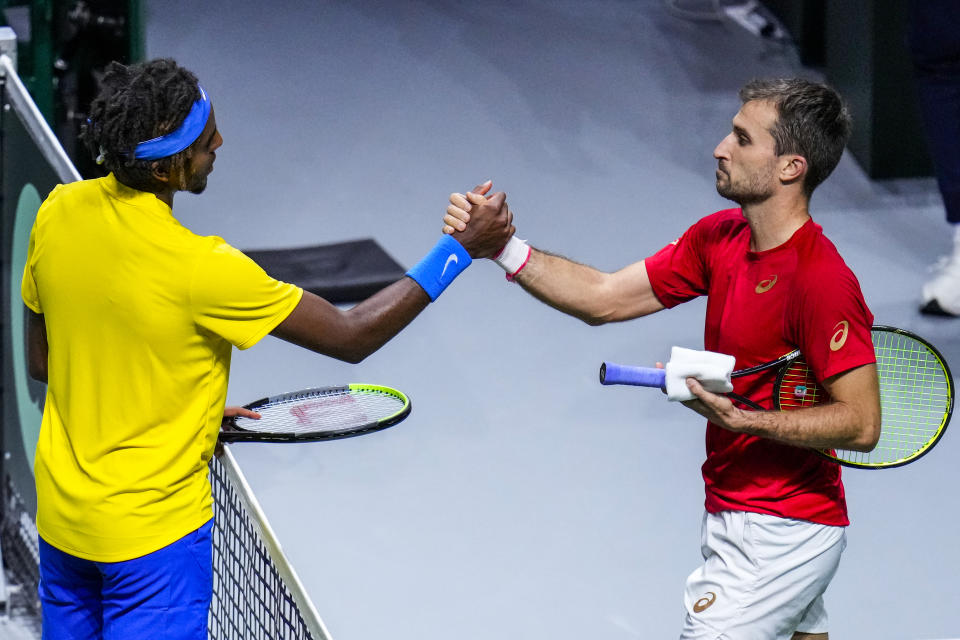 Sweden's Elias Ymer, left, shakes hands after beating Canada's Steven Diez during their Davis Cup tennis match in Madrid, Spain, Thursday, Nov. 25, 2021. (AP Photo/Manu Fernandez)