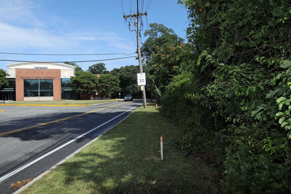 Hommocks Road separating the Hommocks Middle School auditorium and Hampshire Country Club, July 3, 2023 in Mamaroneck. Mamaroneck School District is considering a memorandum of understanding with the developer to accept a gift of land next to Hommocks Middle School that would allow for playing fields and expansion of the building. 