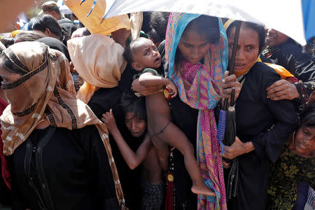 Rohingya refugees wait to receive aid in Cox's Bazar, Bangladesh, September 25, 2017. REUTERS/Cathal McNaughton