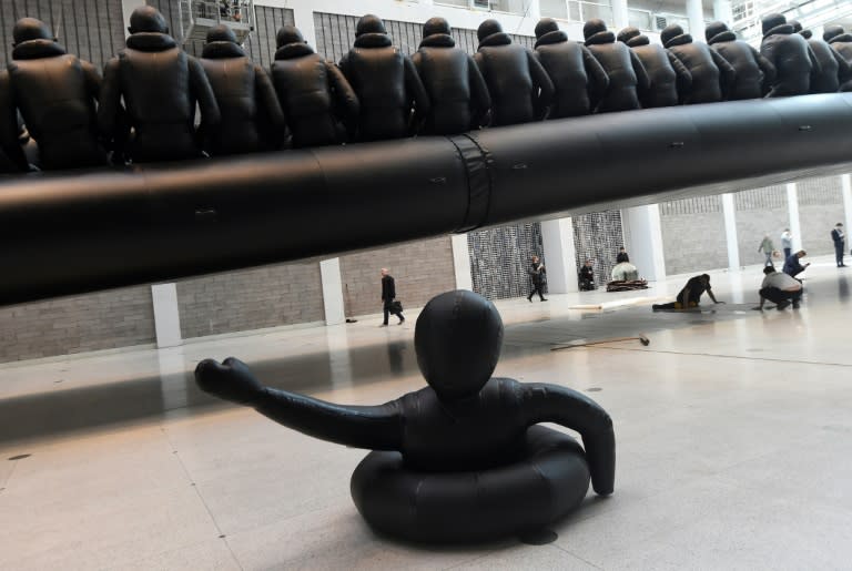 Chinese dissident artist Ai Weiwei's giant installation at Prague's National Gallery is a 70-metre (230-foot) long inflatable boat with 258 oversize refugee figures onboard