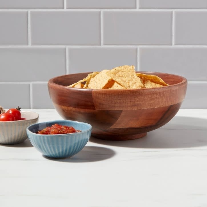 A wood serving bowl with chips