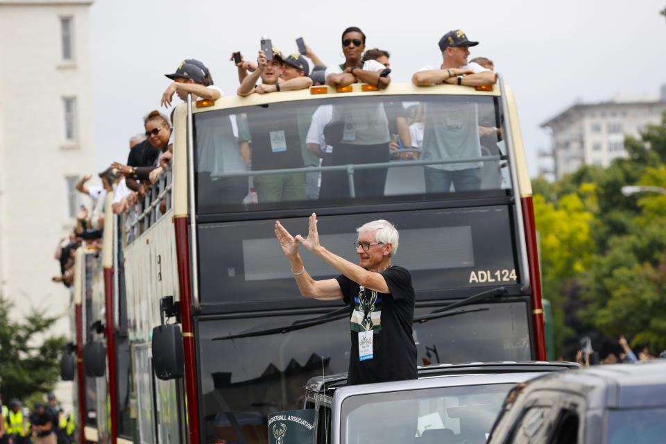 Wisconsin Governor Tony Evers takes part in a parade during a celebration for the NBA Championship Milwaukee Bucks basketball team Thursday, July 22, 2021, in Milwaukee. (AP Photo/Jeffrey Phelps)