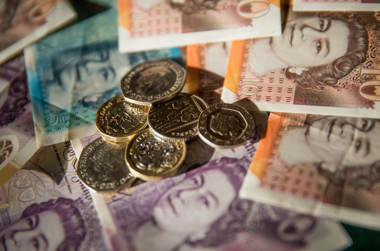 BRISTOL, UNITED KINGDOM - JANUARY 22: In this photo illustration Sterling British Pound GBP bank notes and coins are arranged, on January 22, 2022 in Bristol, England. The UK is currently facing a cost of living crisis, as inflation hits a near-30-year high and rising energy bills will squeeze household incomes still further. To add to the misery, many UK households face a further rises in home energy prices when the energy price cap is likely to be raised in April.  (Photo by Matt Cardy/Getty Images)