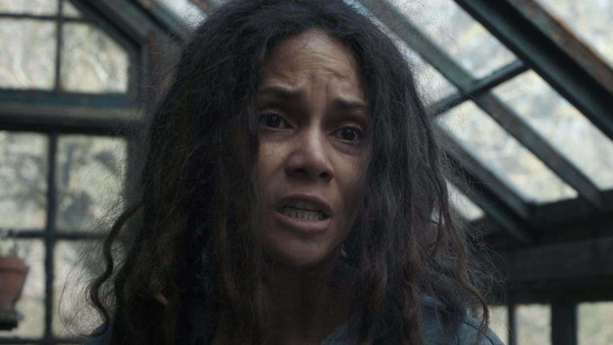 Halle Berry's mother character inside a greenhouse talking to her sons in Never Let Go. 