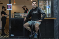 Director and founder of Black Velvet coffee shop Darren Silverman poses for a photo outside his cafe in Melbourne, Australia, Wednesday, Oct. 28, 2020. Silverman reopened his coffee shop Wednesday first time since it was closed in late March due to the virus outbreak. (AP Photo/Asanka Brendon Ratnayake)