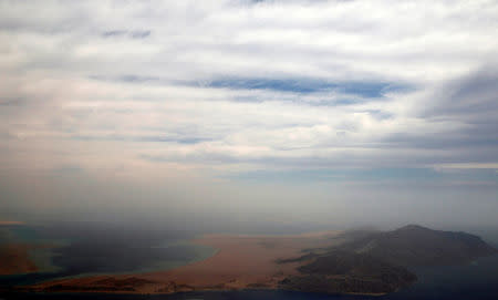 An aerial view of the coast of the Red Sea and the two islands of Tiran and Sanafir is pictured through the window of an airplane near Sharm el-Sheikh, Egypt November 1, 2016. REUTERS/Amr Abdallah Dalsh