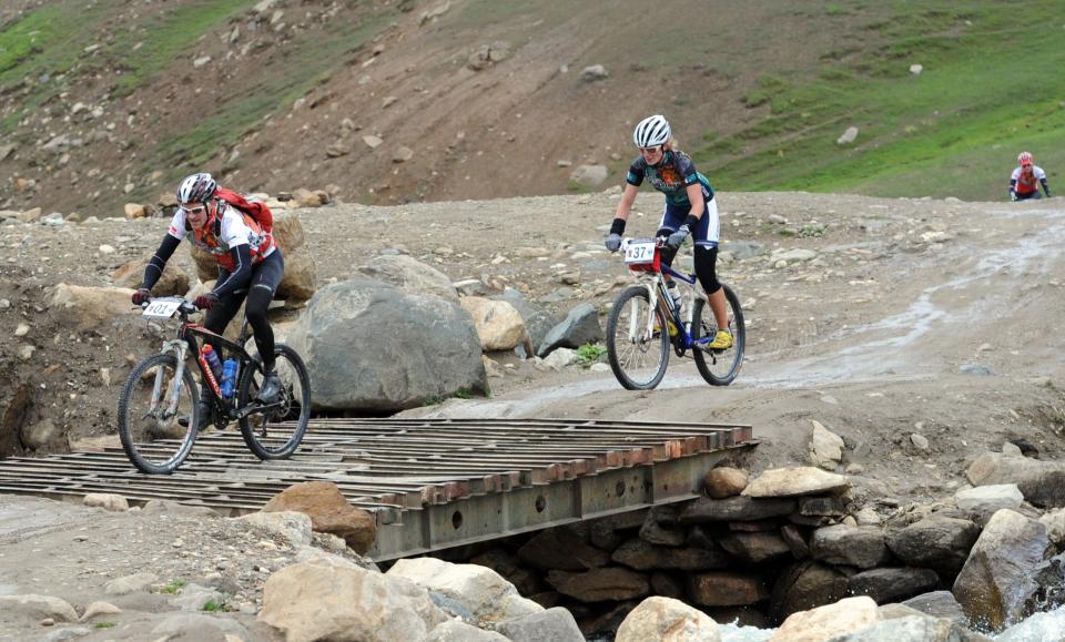 Denmark's Tim Lorentzen (L) and Khyber Pakhtunkhwa's Steffi Hadraschek-Lochen ride during the first stage of the Himalayas 2011 International Mountainbike Race in the mountainous area of Gitti Das in Pakistan's tourist region of Naran in Khyber Pakhtunkhwa province on September 16, 2011. The cycling event, organised by the Kaghan Memorial Trust to raise funds for its charity school set up in the Kaghan valley for children affected in the October 2005 earthquake, attracted some 30 International and 11 Pakistani cyclists. AFP PHOTO / AAMIR QURESHI (Photo credit should read AAMIR QURESHI/AFP/Getty Images)