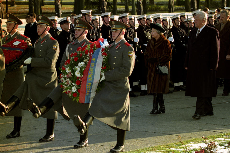 <p>The Queen and Russian president Boris Yeltsin walk behind soldiers carrying wreaths at Piskarevskoye Cemetery in St Petersburg, where those who died during the siege of the city by Germans are buried. It was one of the most significant foreign visits of her reign. (PA Images via Getty Images)</p> 
