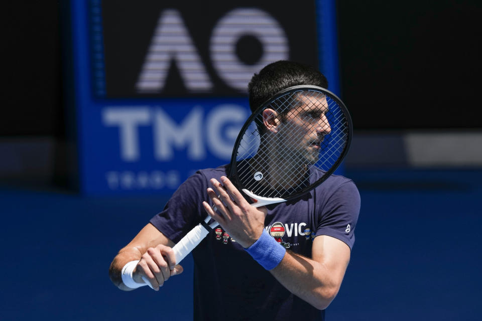 FILE - Defending men's champion Serbia's Novak Djokovic practices on Rod Laver Arena ahead of the Australian Open tennis championship in Melbourne, Australia, Jan. 12, 2022. Djokovic’s effort to play in the Australian Open despite being unvaccinated for COVID-19 moved to a higher court as the No. 1-ranked tennis player appealed the second cancellation of his visa. A judge scheduled another hearing for Sunday, Jan. 16. (AP Photo/Mark Baker, File)