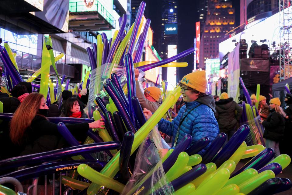 Balloons are handed out to revellers gathered at Times Square during the New Year’s Eve celebrations, in New York City, New York, US, 31 December 2023 (Reuters)