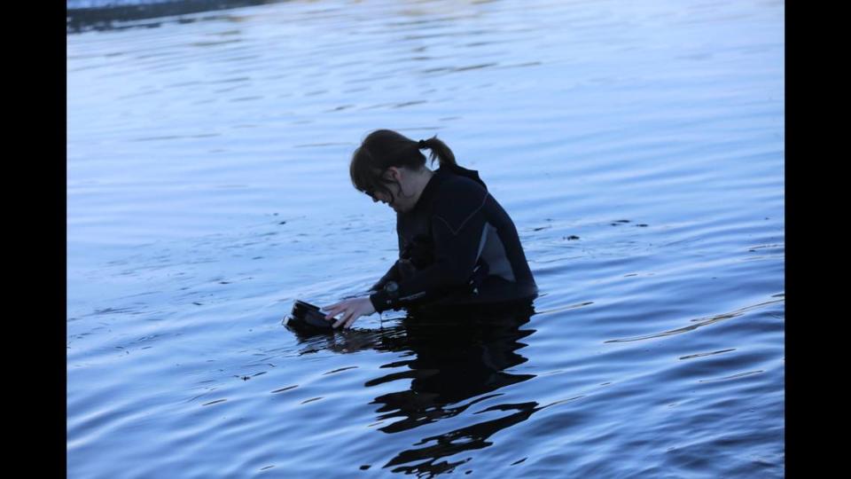 Aquarist Tiffany Rudek takes measurements at Yaquina Bay.