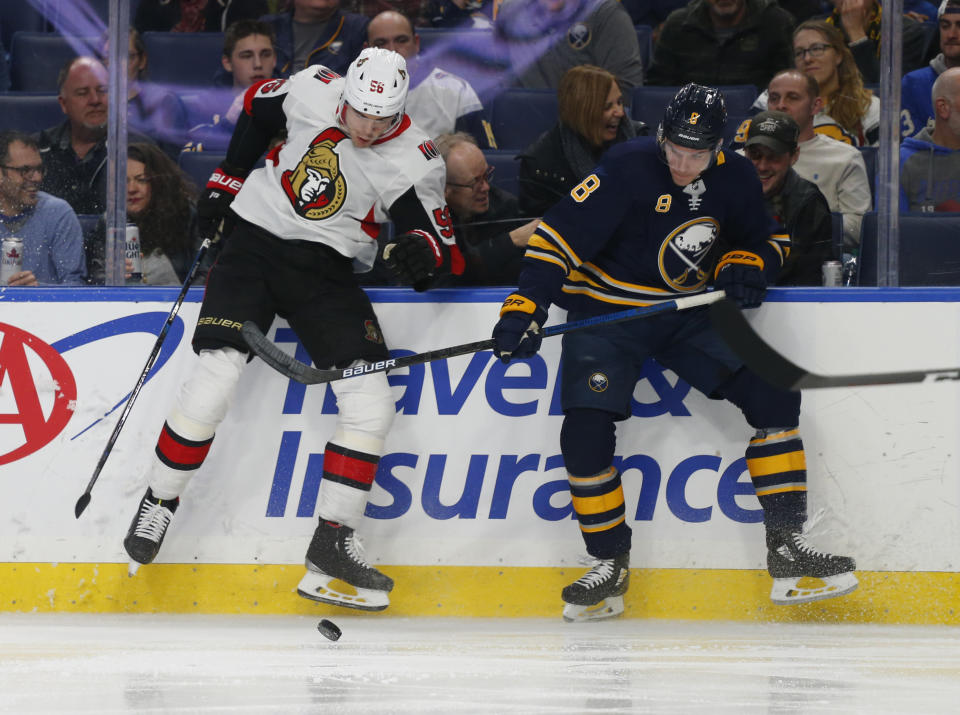 Buffalo Sabres defenseman Casey Nelson (8) and Ottawa Senators forward Magnus Paajarvi (56) collide during the second period of an NHL hockey game Thursday, April 4, 2019, in Buffalo, N.Y. (AP Photo/Jeffrey T. Barnes)