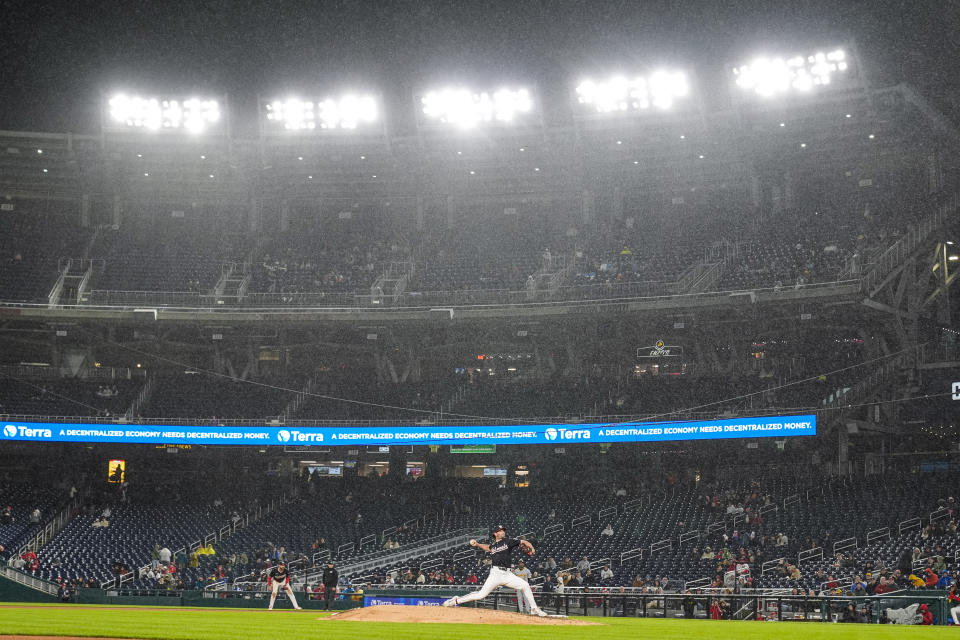 Washington Nationals relief pitcher Kyle Finnegan throws in the rain during the ninth inning of the team's baseball game against the Pittsburgh Pirates at Nationals Park, Wednesday, April 3, 2024, in Washington. (AP Photo/Alex Brandon)