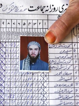 FILE PHOTO: A picture of John Walker Lindh is shown on the attendance register of the madrassa (Islamic school) Arabia Hassani Kalan Surani Bannu, in Bannu in Pakistan, January 26, 2002. REUTERS/Haider Shah/File Photo