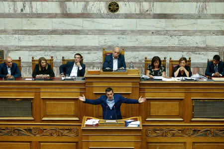 Greek Prime Minister Alexis Tsipras addresses lawmakers during a parliamentary session before a vote following a motion of no confidence by the main opposition in dispute over a deal on neighbouring Macedonia's name, in Athens, Greece June 16, 2018. REUTERS/Costas Baltas