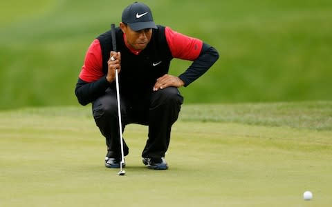 Tiger Woods of the United States looks over a putt on the second green during the final round of The PLAYERS Championship - Credit: Getty Images