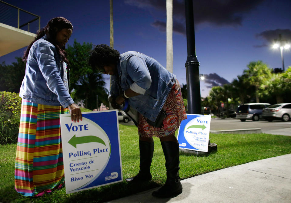 Placing voting signs in Miami, Fla.