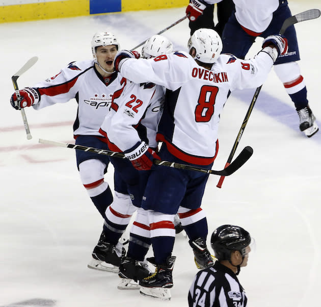 Washington Capitals’ Kevin Shattenkirk (22) celebrates with Dmitry Orlov (9), and Alex Ovechkin (8) after score the game-winning goal in overtime of Game 3 in an NHL Stanley Cup Eastern Conference semifinal hockey game against the Pittsburgh Penguins in Pittsburgh, Monday, May 1, 2017. The Capitals won 3-2. (AP Photo/Gene J. Puskar)
