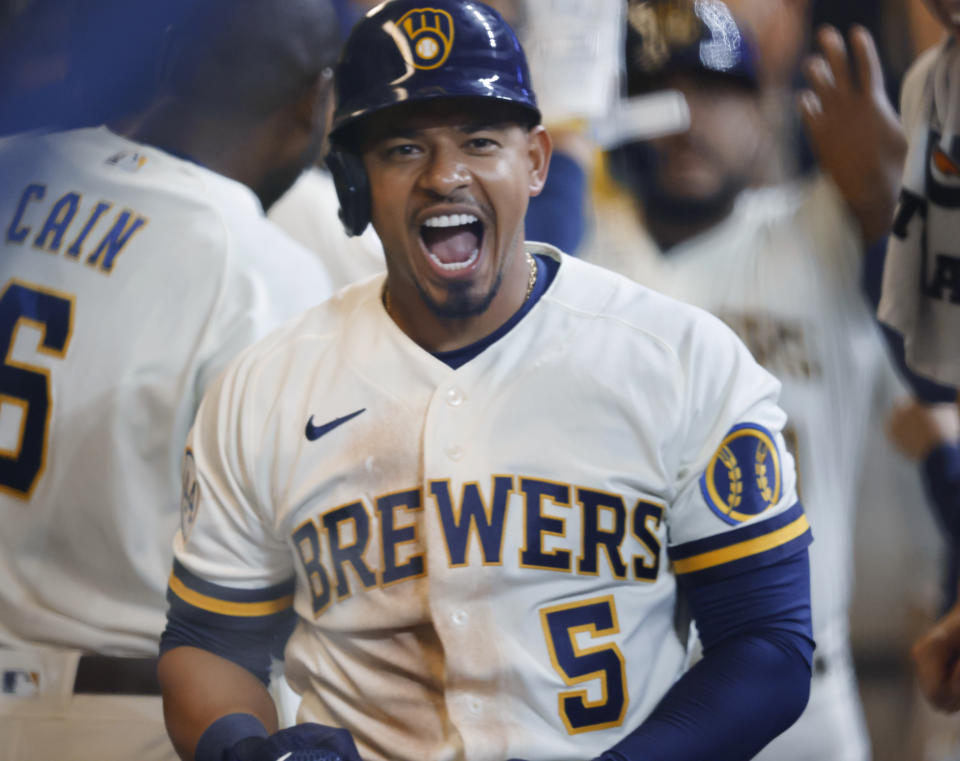 Milwaukee Brewers' Eduardo Escobar celebrates in the dugout after his three-run home run against the Pittsburgh Pirates during the seventh inning of a baseball game Monday, Aug. 2, 2021, in Milwaukee. (AP Photo/Jeffrey Phelps)