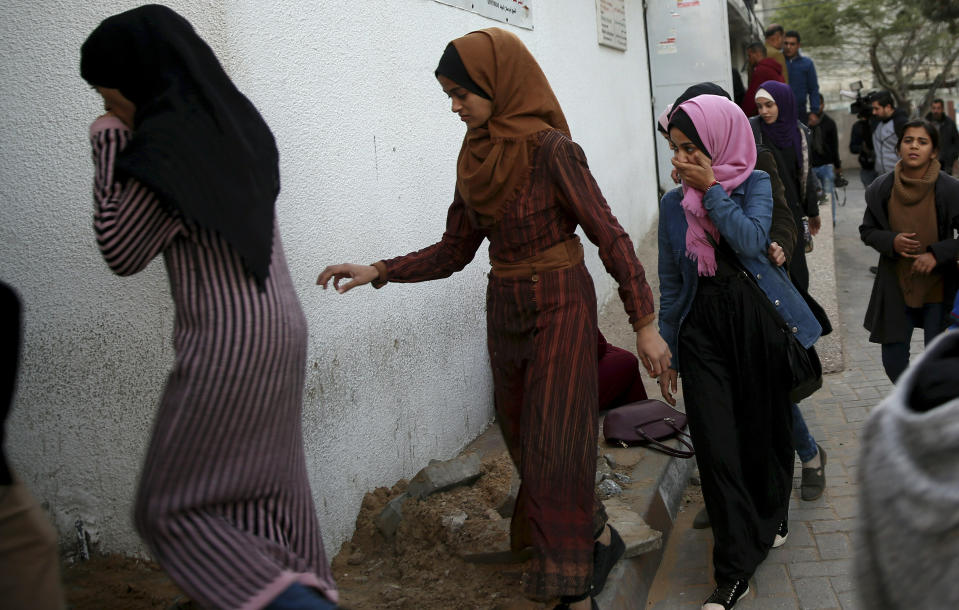 Relatives arrive to the morgue of Shifa hospital to see the body of a woman was killed by Israeli troops during a protest at the Gaza Strip's border with Israel, in Gaza City, Friday, Jan. 11, 2019. Spokesman Ashraf al-Kidra says the woman was shot in the head Friday at a protest site east of Gaza City. (AP Photo/Adel Hana)