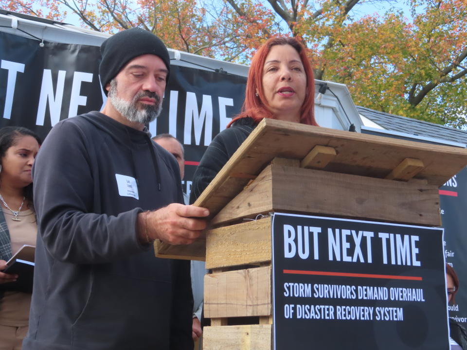 Luis Lopez of New York City, left, and Millie Santiago of Canóvanas, Puerto Rico, right, describe conditions in Puerto Rico after Hurricane Maria in 2017 during an event in Middletown N.J. on Saturday, Oct. 29, 2022 to commemorate the 10th anniversary of Superstorm Sandy. It featured a group of storm survivors from around the country who called for changes in the nation's disaster response system to make them more responsive to victims. (AP Photo/Wayne Parry)