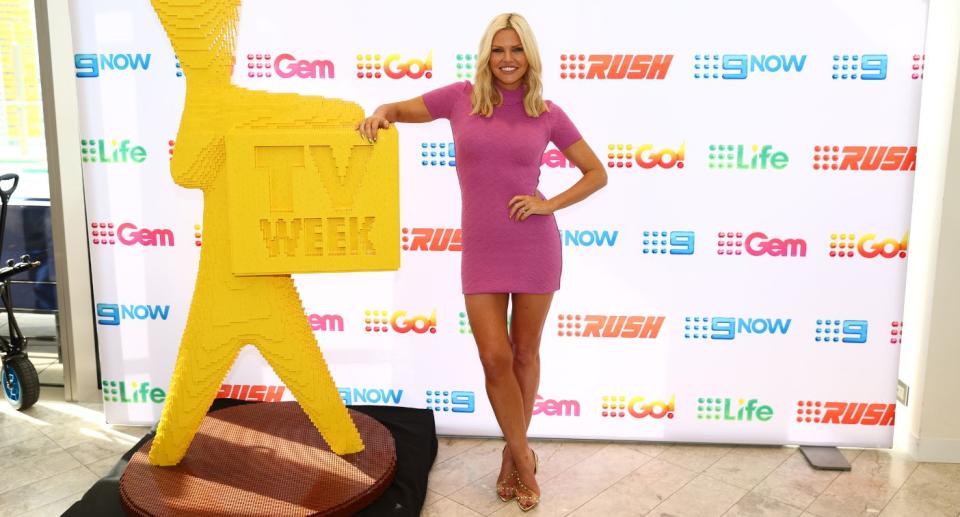 Former Bardot singer Sophie Monk posing on the red carpet with a Lego Logie award