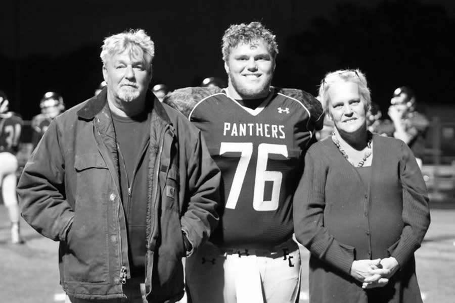 Image: Kim Johnson and her husband Delbert with their son Sam at a high school football game in November 2016. (Courtesy Kim Johnson)