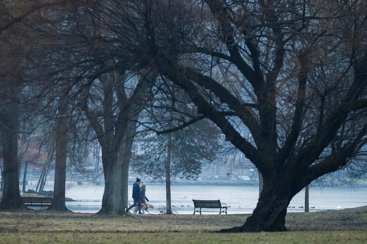 A couple walk their dog along Packanack Lake in Wayne, NJ on Thursday Feb. 1, 2024.