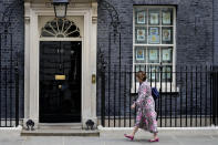 A woman walks towards 10 Downing Street in London, Monday, May 23, 2022. The general public is awaiting the release of Sue Gray's report into COVID lockdown breaches across Whitehall, the so called "Partygate". (AP Photo/Frank Augstein)