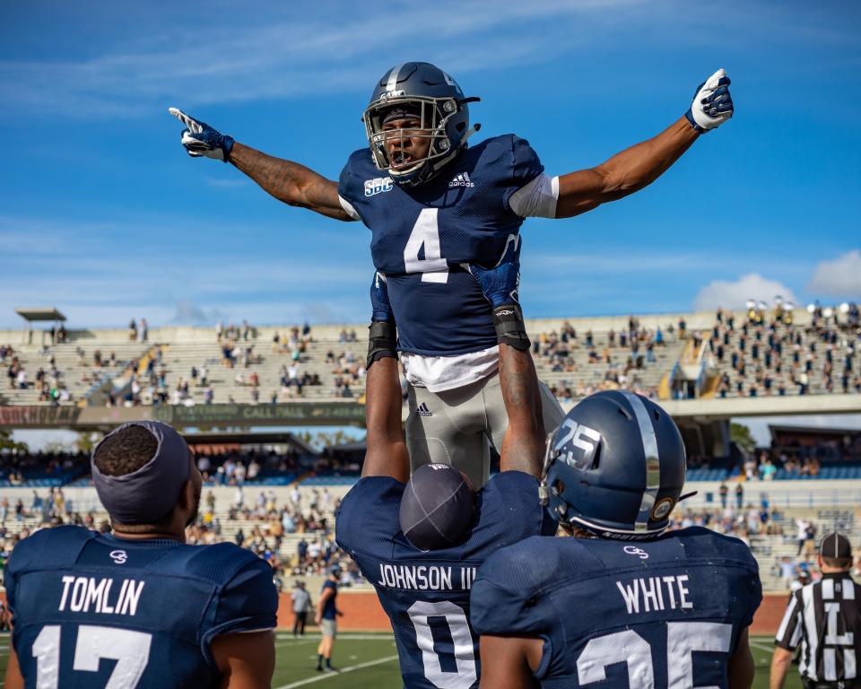 Redshirt freshman running back Gerald Green is lifted up by senior defensive end Raymond Johnson III after Green' 69-yard touchdown run -- the first of his career -- against Troy on Nov. 7, 2020, at Paulson Stadium in Statesboro.