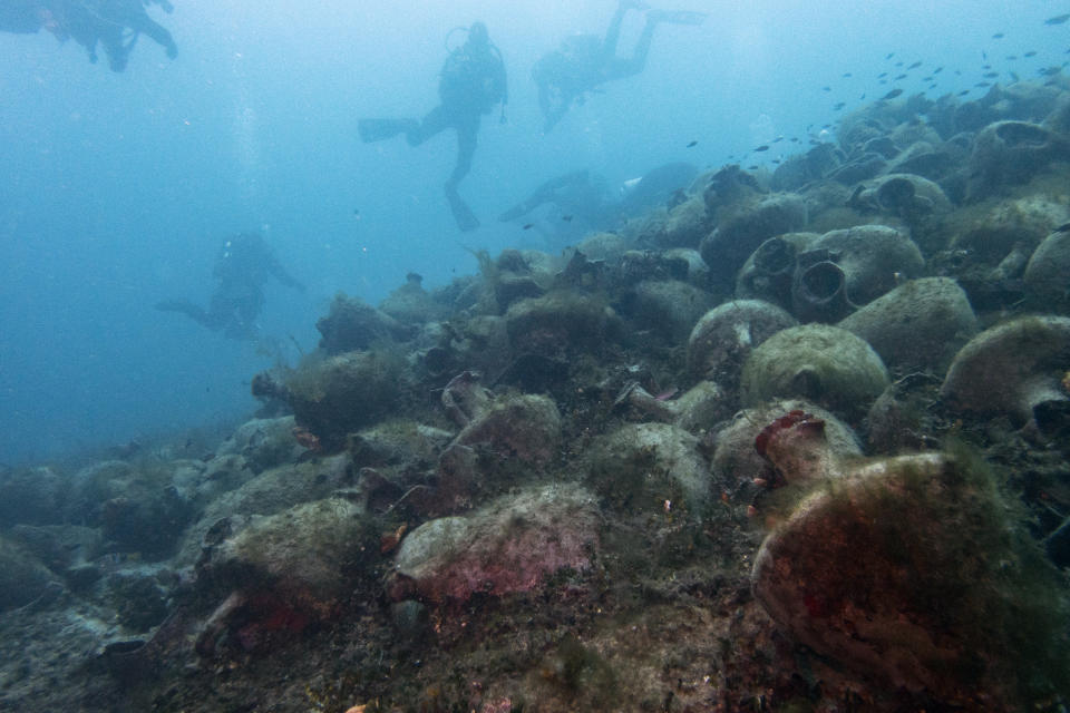 In this photo taken on Sunday, April 7, 2019, divers visit a 5th Century B.C. shipwreck, the first ancient shipwreck to be opened to the public in Greece, including to recreational divers who will be able to visit the wreck itself, near the coast of Peristera, Greece. Greece’s rich underwater heritage has long been hidden from view, off-limits to all but a select few, mainly archaeologists. Scuba diving was banned throughout the country except in a few specific locations until 2005, for fear that divers might loot the countless antiquities that still lie scattered on the country’s seabed. Now that seems to be gradually changing, with a new project to create underwater museums. (AP Photo/Elena Becatoros)