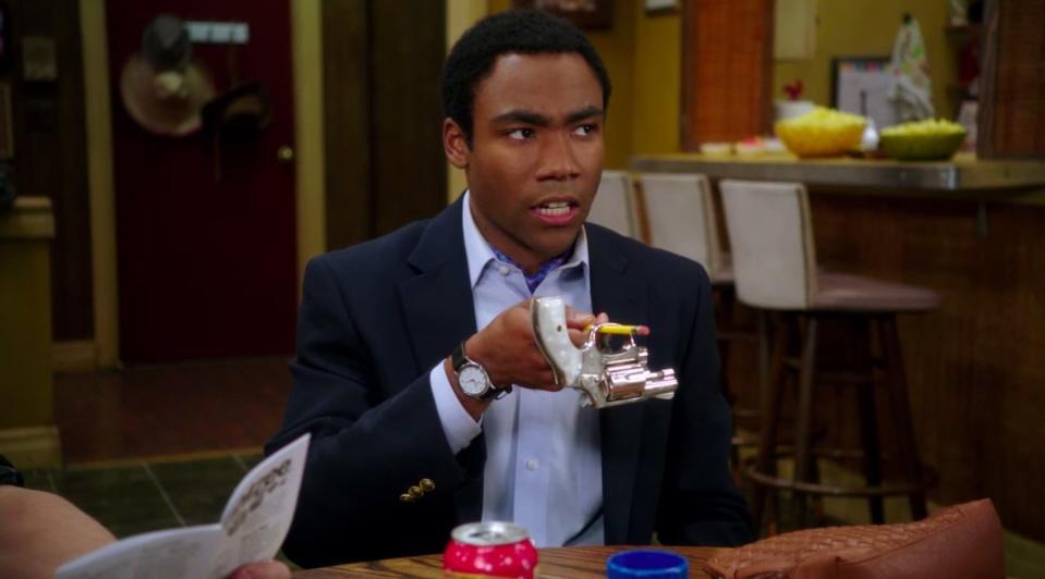 Troy holding a gun with a pencil in "Community"