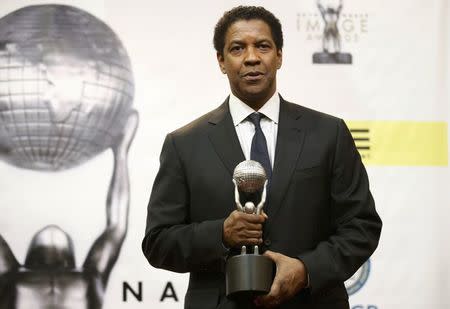 Denzel Washington poses with the award for Outstanding Actor in a Motion Picture for his role in "Fences" backstage at the 48th NAACP Image Awards in Pasadena, California, U.S., February 11, 2017. REUTERS/Danny Moloshok