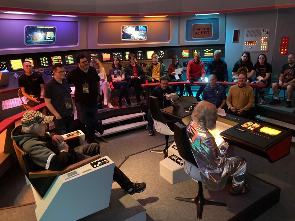 "Star Trek" actors Walter Koenig, seated at the captain's chair, and Clint Howard, seated at the navigation console, talk with fans May 18, 2024 during the "Trekonderoga" gathering at the "Star Trek" Original Series Set Tour site in Ticonderoga, New York.