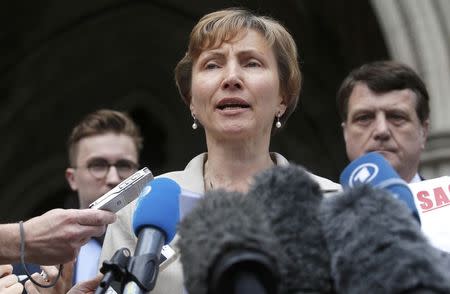 Marina Litvinenko, the widow of murdered KGB agent Alexander Litvinenko, speaks to members of the media as she leaves the High Court in central London, Britain July 31, 2015. REUTERS/Peter Nicholls