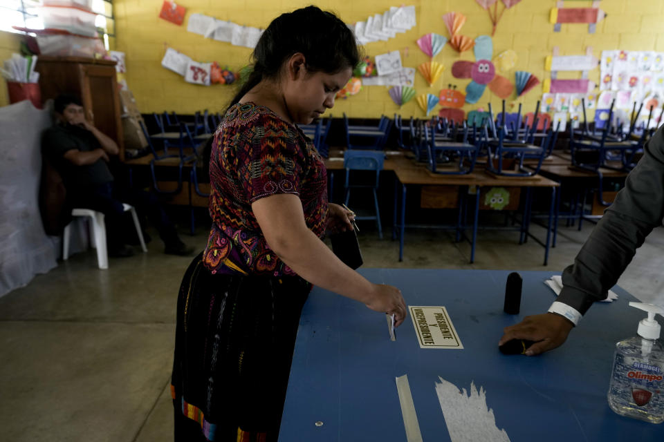 A woman votes during a run-off presidential election in Santa Maria Cauque, Guatemala, Sunday, Aug. 20, 2023. (AP Photo/Moises Castillo)