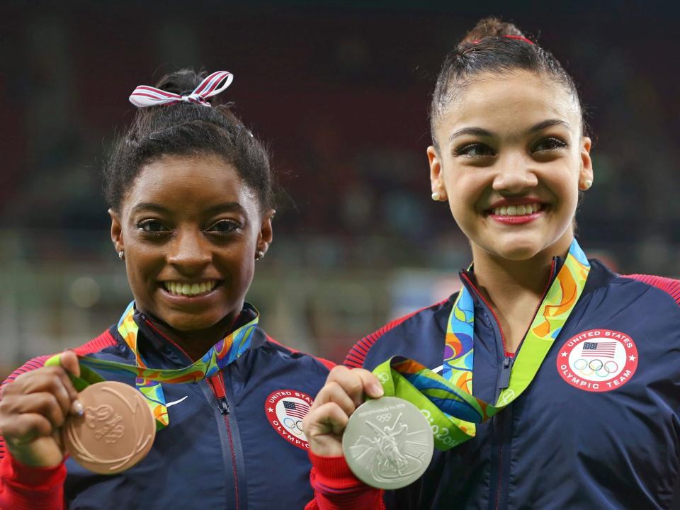 Simone Biles (left) and Laurie Hernandez pose with their medals from the 2016 Olympics balance beam event.