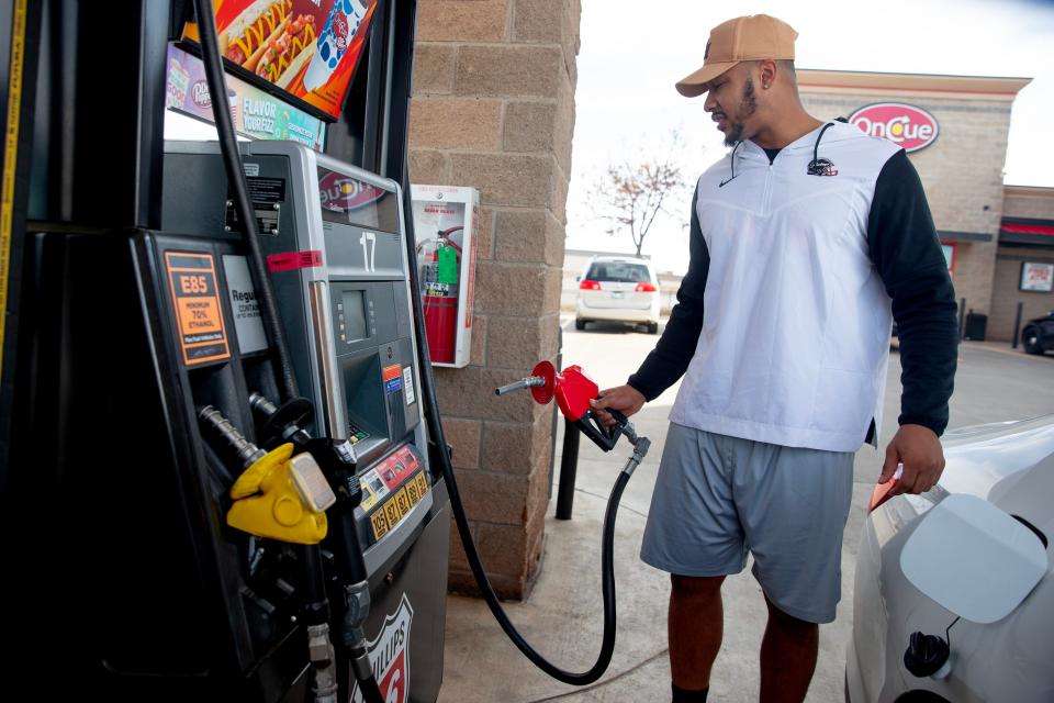 Jordan Brailford gets gas Friday at a gas station in Oklahoma City.