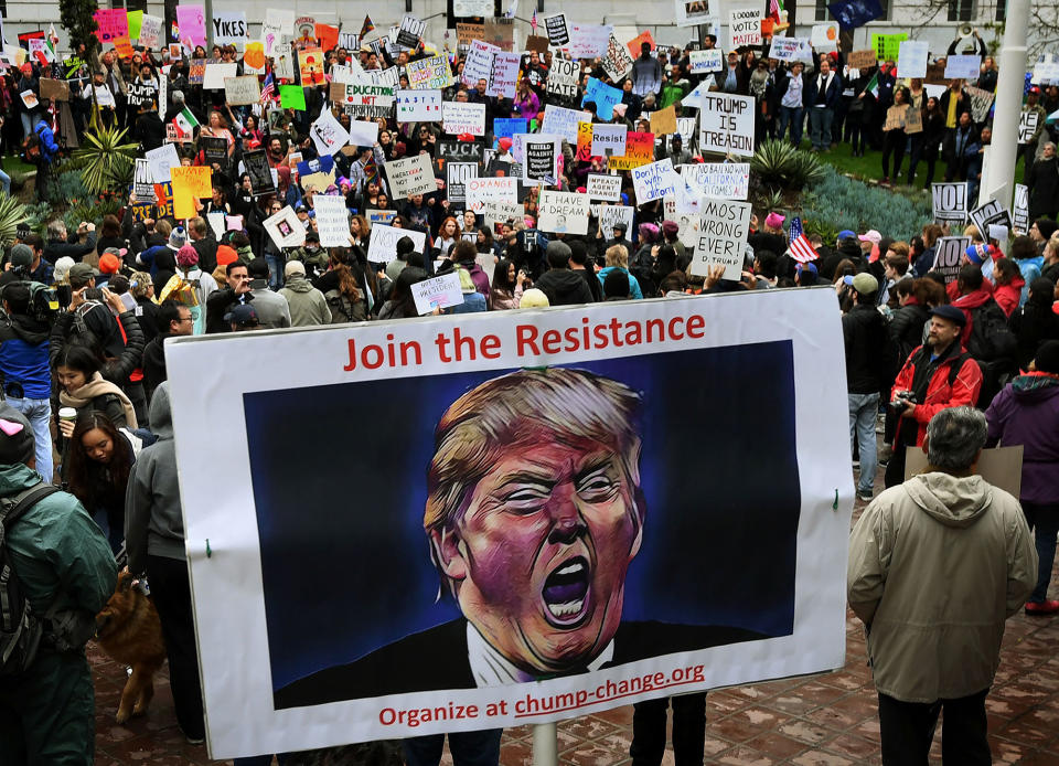 <p>Protesters carry anti-Trump signs during a ‘Not My President’s Day’ demonstration outside City Hall in Los Angeles, on Feb. 20, 2017. (Mark Ralston/AFP/Getty Images) </p>