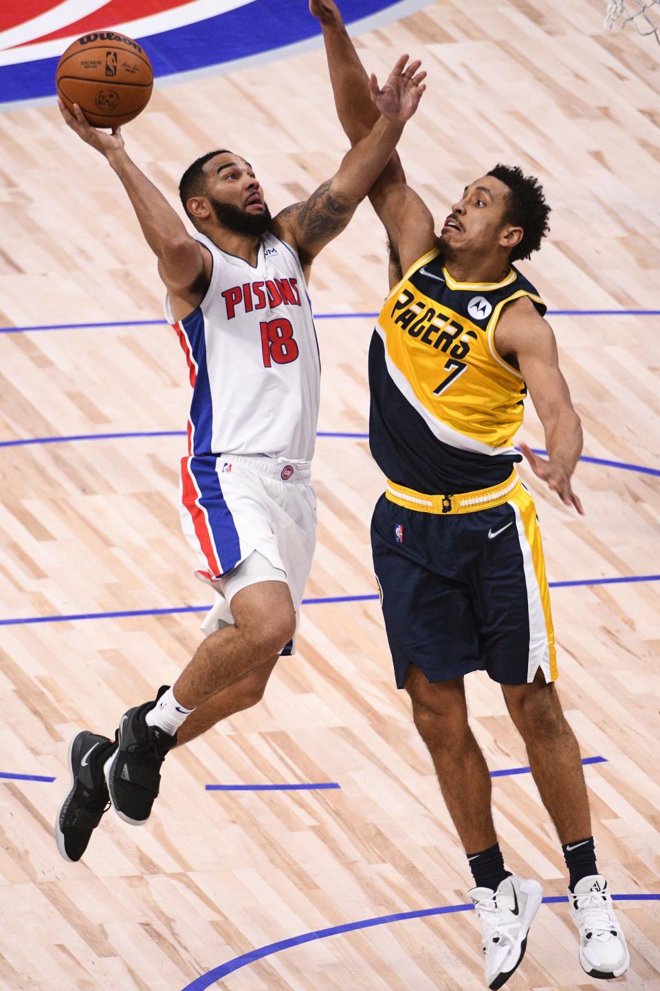 Pistons guard Cory Joseph (18) goes to the basket as Indiana Pacers guard Malcolm Brogdon (7) defends during the third quarter on Nov. 17, 2021, at Little Caesars Arena in Detroit.