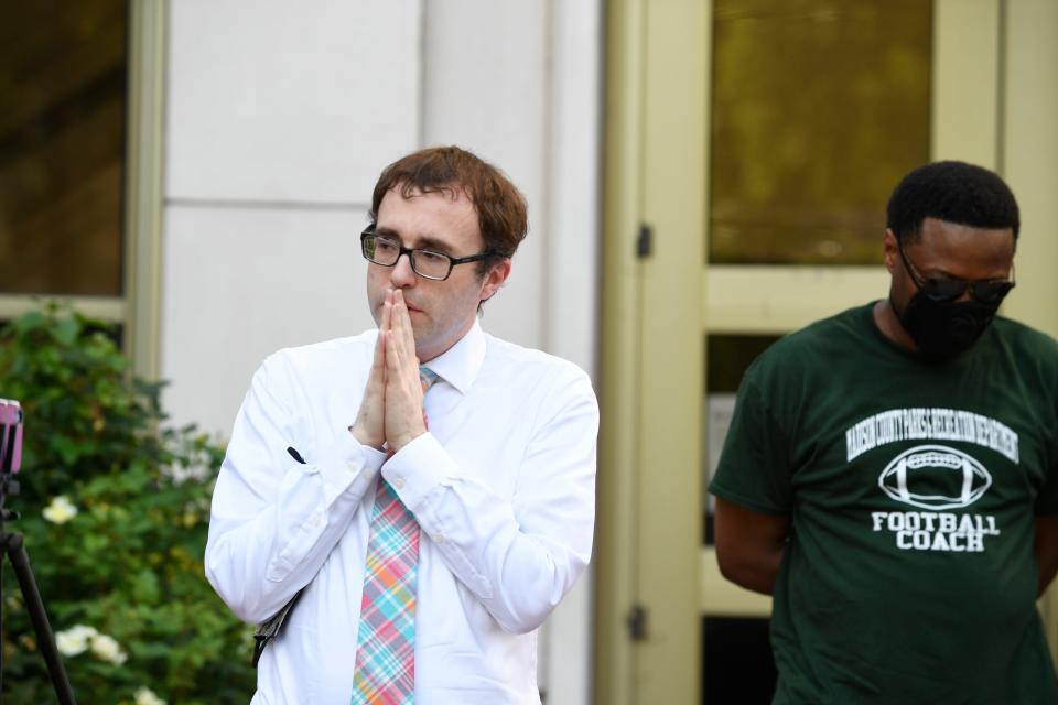 Jackson's City Administrative Assistant Alex Reed  prays with the community in front of the City Hall in Jackson, Tenn., Tuesday, June 2, 2020. The community peacefully protest against police violence towards the African American community.