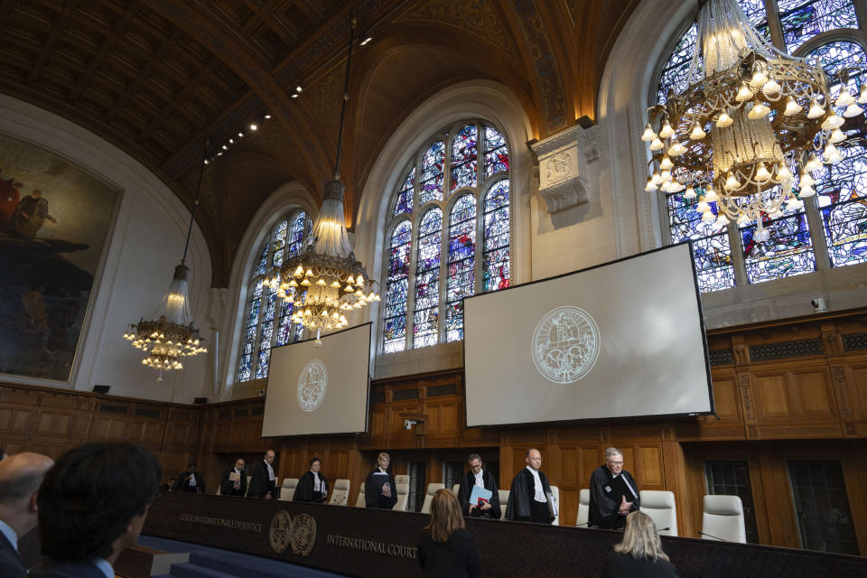 All rise as judges enter the International Court of Justice, or World Court, in The Hague, Netherlands, Wednesday, May 1, 2024. Mexico is taking Ecuador to the United Nations' top court on Tuesday accusing the nation of violating international law by storming into the Mexican embassy in Quito on April 5, and arresting former Ecuador Vice President Jorge Glas, who had been holed up there seeking asylum in Mexico. (AP Photo/Peter Dejong)