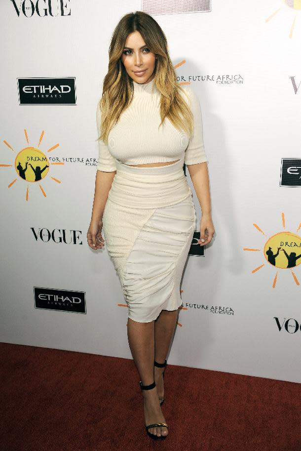 FILE - This Oct. 24, 2013 file photo shows TV personality Kim Kardashian at the inaugural Dream for Future Africa Foundation Gala in Beverly Hills, Calif. Kanye West says when it comes to fashion, Kim Kardashian reigns supreme over every woman, including Michelle Obama. In an interview Tuesday with Ryan Seacrest, the rapper said he and his fiancé are “the most influential with clothing.” (Photo by Richard Shotwell/Invision/AP, File)