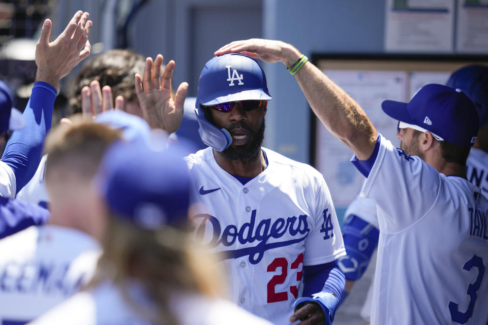 Los Angeles Dodgers' Jason Heyward (23) celebrates in the dugout after scoring off of a sacrifice fly by David Peralta during the fourth inning of a baseball game against the New York Mets in Los Angeles, Wednesday, April 19, 2023. (AP Photo/Ashley Landis)