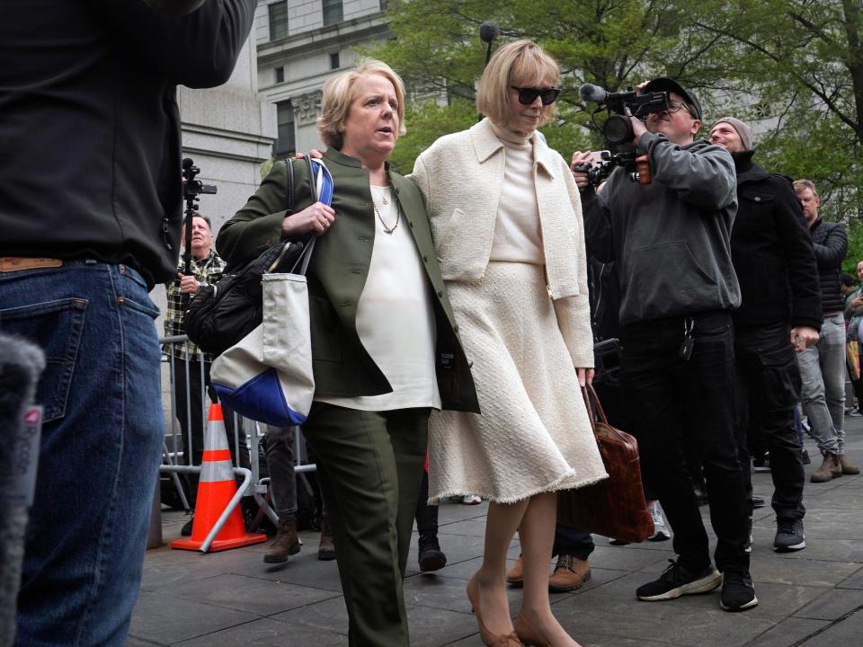 Former advice columnist E. Jean Carroll, right, leaves federal court with her lawyer, Roberta Kaplan, after her second day on the witness stand in federal court in Manhattan.