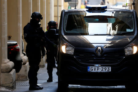 Armed police officers of the Malta Police Special Intervention Unit provide security as three men, accused of the assassination of anti-corruption journalist Daphne Caruana Galizia, leave after their lawyers’ submissions for bail at the Courts of Justice in Valletta, Malta April 17, 2018. REUTERS/Darrin Zammit Lupi