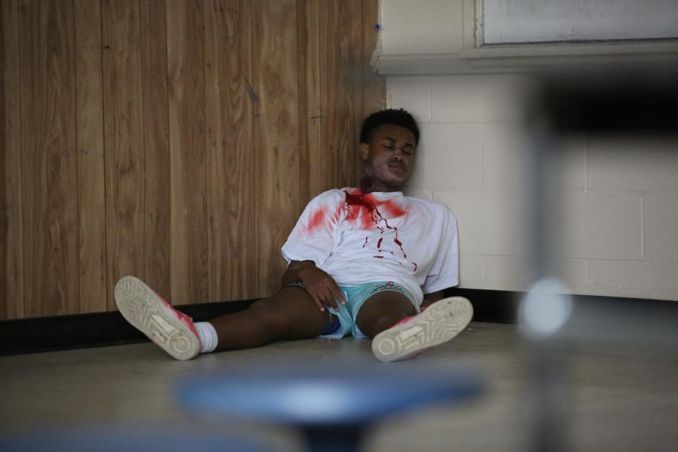 A Gadsden County High School student pretends to be dead during an active shooter training for first responders, Dec. 4, 2023.